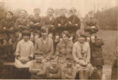 This school photo was taken at the Fair Green, probably opposite or very near to The Church of Ireland School there. The children are sitting on The Green wall. Only 3 children are named. In the front row L to R is Noel Kerr, Norman Coffey and Sydney Kerr. Courtesy of Peter Coffey